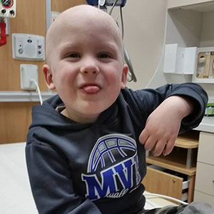 child with cancer having fun at hospital